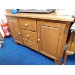 A 20thC. sideboard with two cupboards & three draw