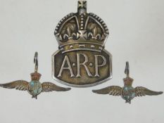 A silver ARP badge & two silver RAF badges