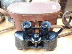 A small pair of French binoculars with case