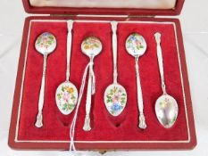 A set of silver enamelled spoons, one damaged