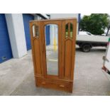 A satinwood wardrobe with mirrored inserts