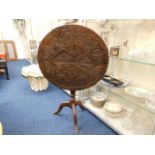 An 18thC. carved oak birdcage table