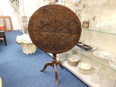 An 18thC. carved oak birdcage table