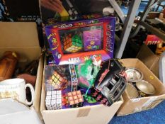 A boxed quantity of toys including several Rubiks