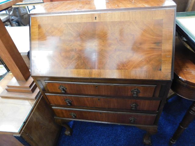 A mahogany bureau with ball & claw feet