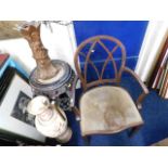 An antique chair, a marble topped pedestal, a spel