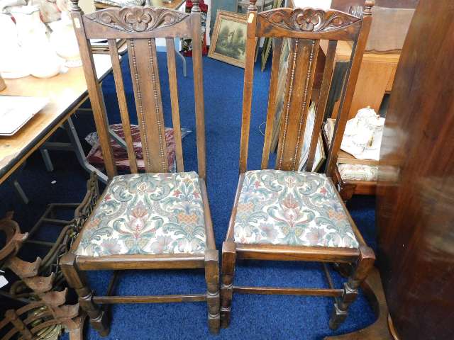 A pair of oak dining chairs with Liberty style uph