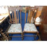 A pair of oak dining chairs with Liberty style uph