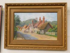 A 19thC. framed oil painting of village street sce