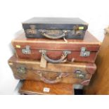 A leather tan suitcase & two others