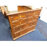 A gothic style oak chest of drawers