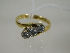 A ladies 18ct gold diamond three stone ring