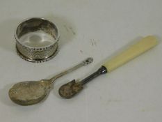 A silver caddy spoon twinned with a napkin ring &