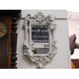 An ornate shabby chic mirror with putti & organic