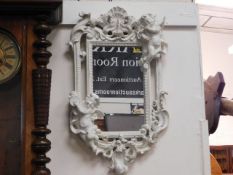 An ornate shabby chic mirror with putti & organic