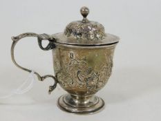 A 20thC. white metal mustard with engraved decor