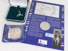 A silver proof crown, one other coin & a Cornish t