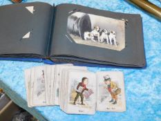 A small postcard album & an antique card game