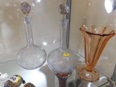 A pair of antique glass decanters twinned with ear