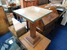 A pair of small art deco teak pedestal tables