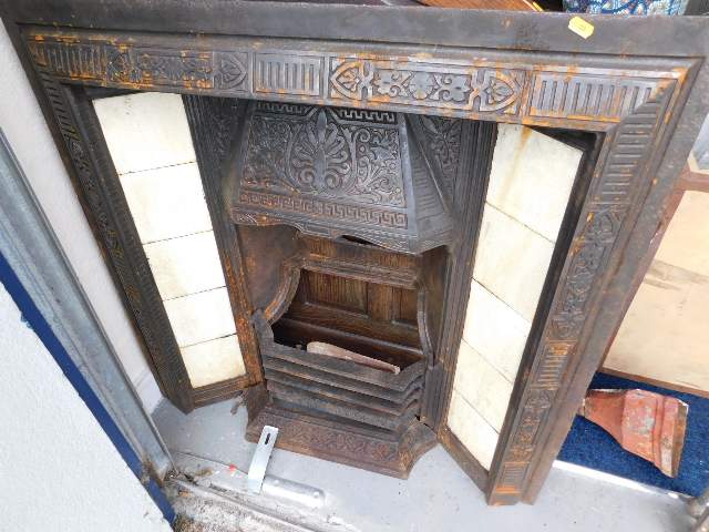 A Victorian cast iron fire insert, a cast iron hop