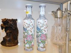 A pair of hand decorated famille rose style Chines