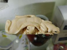 A c.1900 Japanese carved ivory netsuke of frogs em