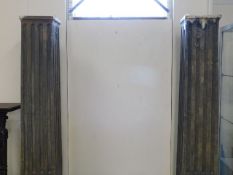 A pair of Corinthian style theatrical pillars