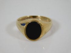 A 9ct gold black onyx signet ring