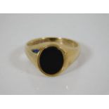 A 9ct gold black onyx signet ring