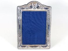 A silver photo frame with relief decor