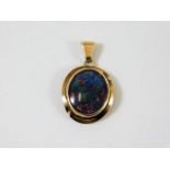 An antique yellow metal black opal pendant