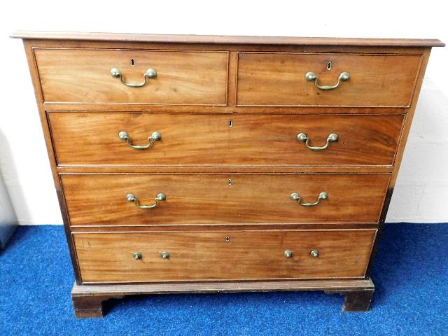A Georgian mahogany two piece chest of drawers wit