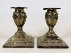 An embossed pair of Victorian silver candlesticks