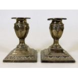 An embossed pair of Victorian silver candlesticks