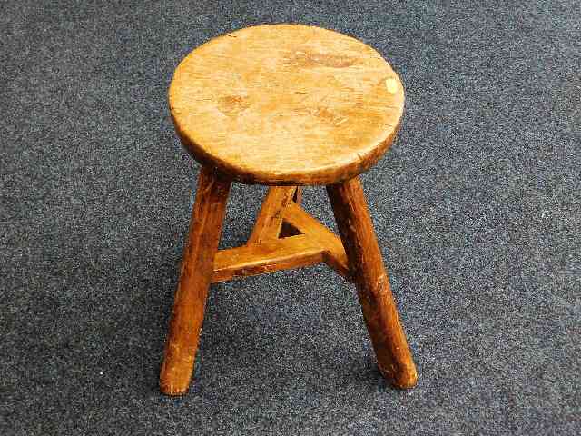 A very rustic farmhouse milking stool