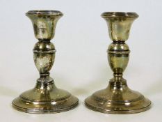 A pair of silver candlesticks, one repaired