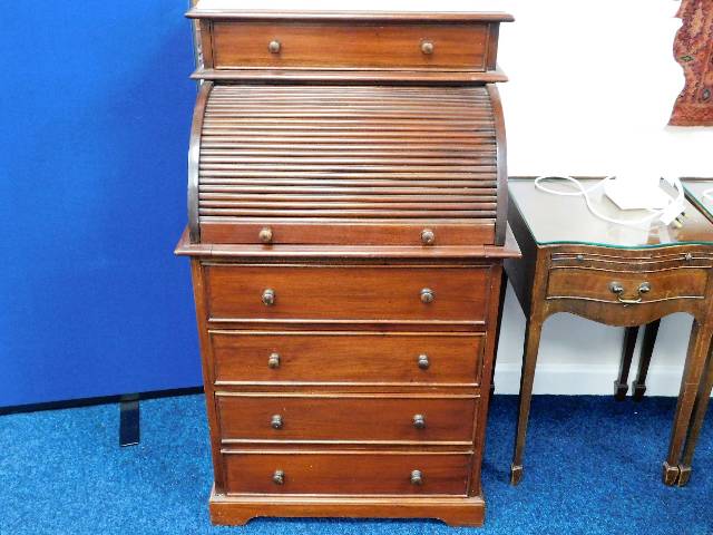 A small antique mahogany roll top desk