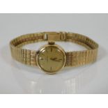A ladies 9ct gold Omega watch inscribed to rear H.