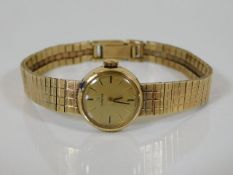 A ladies 9ct gold Omega watch inscribed to rear H.