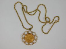 A mounted full gold sovereign with chain