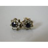 A pair of 9ct earrings set with sapphire & white s