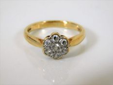 A 9ct gold daisy ring with diamonds