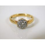 A 9ct gold daisy ring with diamonds