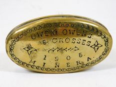 An antique brass snuff box inscribed Owen Owens 5
