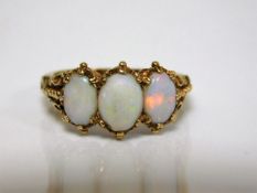 An antique 18ct gold opal trilogy ring