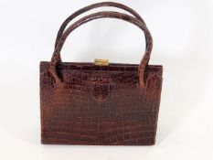 A vintage crocodile skin ladies handbag