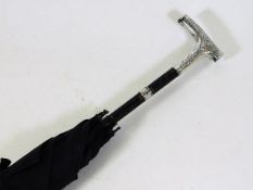 A ladies early 20thC. silver handled umbrella