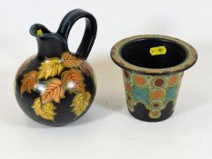 A Dutch pottery Gouda jug twinned with a Gouda hat