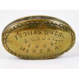 An antique brass snuff box inscribed Thomas Owen 5